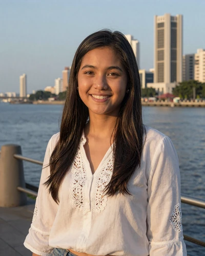 Angela, 24, Filipino woman at Manila waterfront promenade at sunset