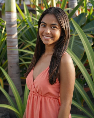 Chessa, 24, Filipino woman in coral sundress near tropical greenery in Cebu