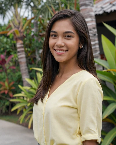 Jasmine, 25, Filipino woman from Cebu City smiling near tropical garden