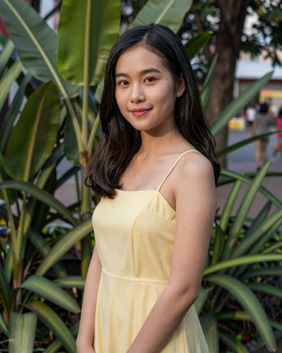 Trang, 24, Vietnamese woman in pastel sundress at park in Ho Chi Minh City