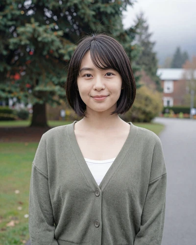 Suki, 23, Japanese American woman in a Seattle park with evergreen trees